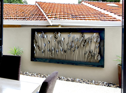 example of large outdoor metal wall art of lilies and tulips in silver